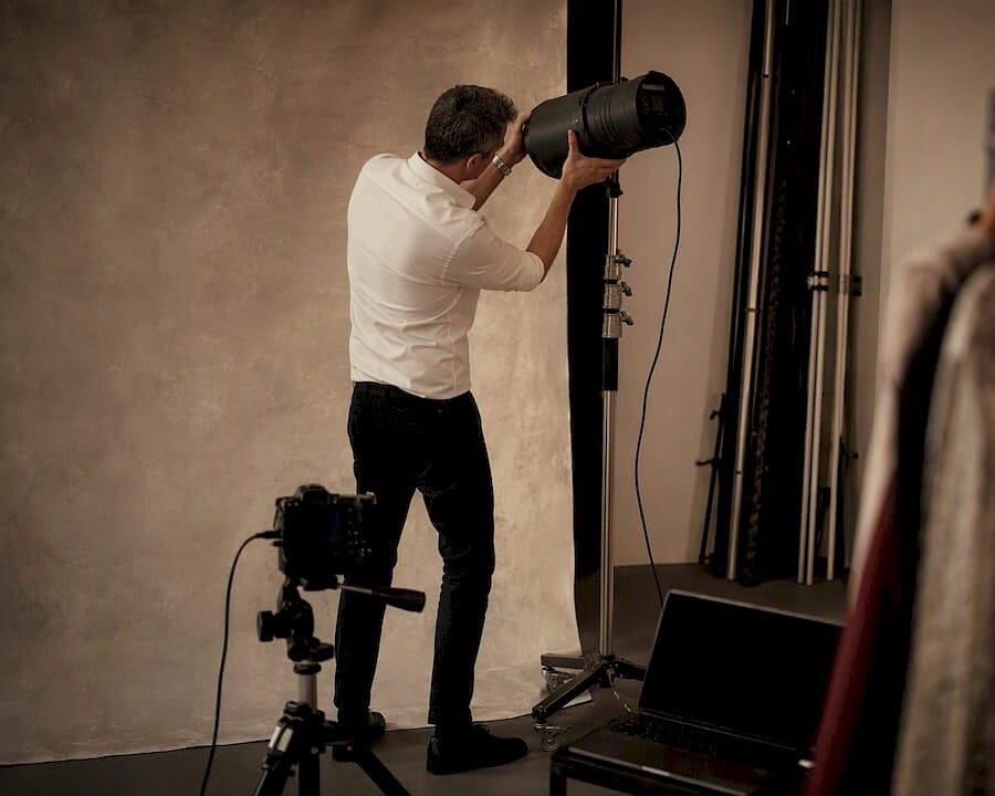 Photographer adjusting studio light in NYC studio