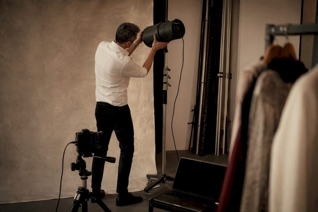 Photographer adjusting studio light in NYC studio