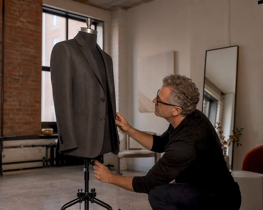 Photographer adjusting ghost mannequin setup