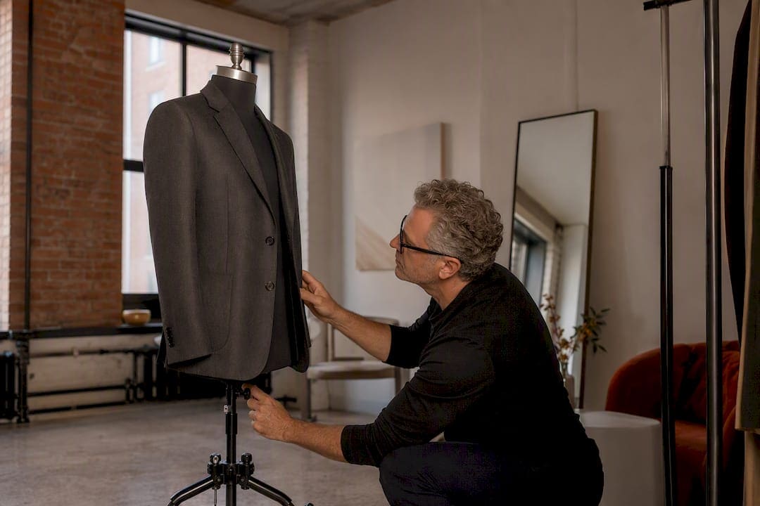 Photographer adjusting ghost mannequin setup