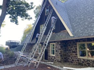 Installing new windows and siding on a house during renovation project.