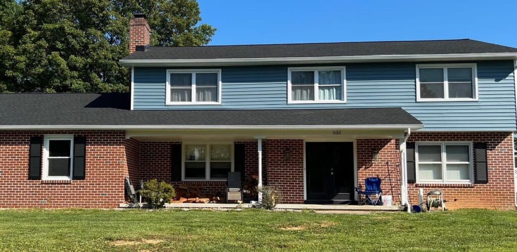 Exterior view of a renovated house with new roofing and siding in Bethlehem PA.