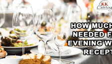 Elegant catering table with drinks and food for wedding reception.