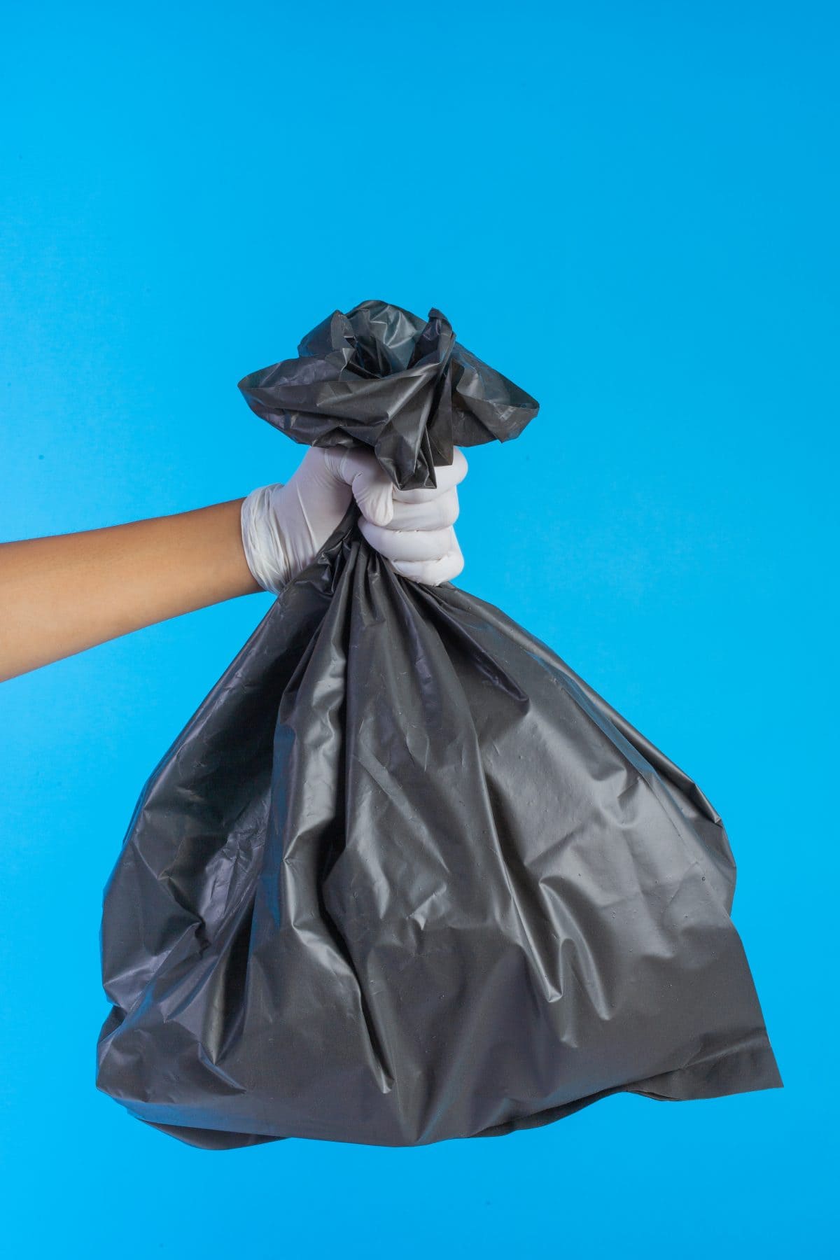 Black rubbish bag, waste disposal, garbage collection, eco-friendly waste management, trash bag, cleanup, environmental care, black refuse sack.