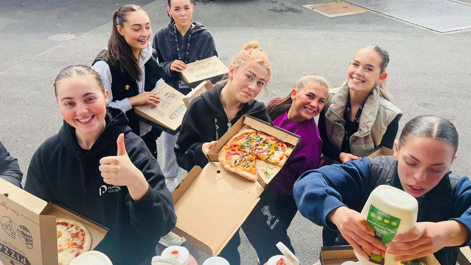 Freshly delivered pizza from KK Catering for school event, enjoying top-quality food and catering services.