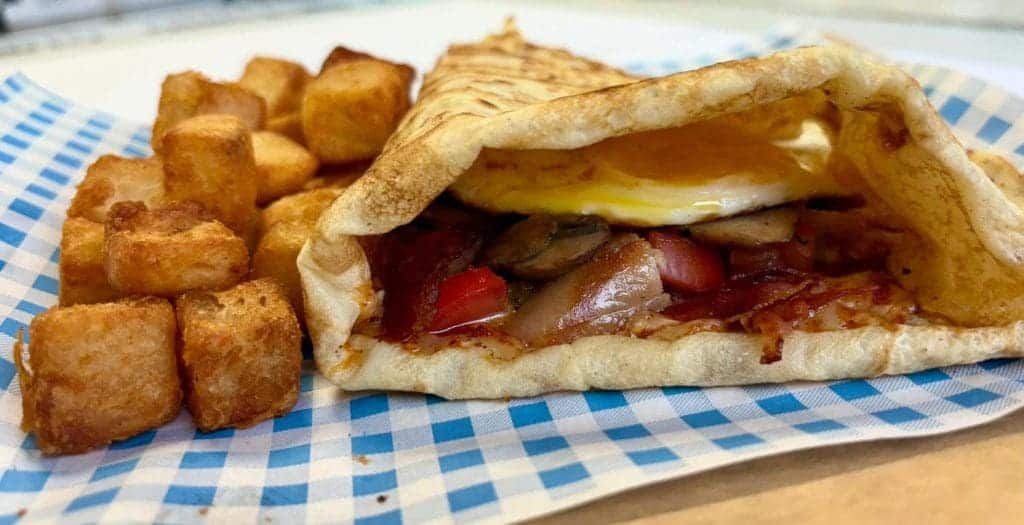 breakfast crepe served with breakfast potatoes
