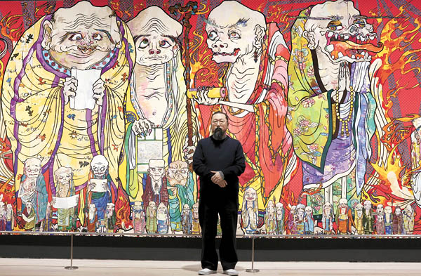 Japanese artist Takashi Murakami poses in front of part of his work titled “The 500 Arhats” exhibited at Mori Art Museum in Tokyo. [AP/NEWSIS] 