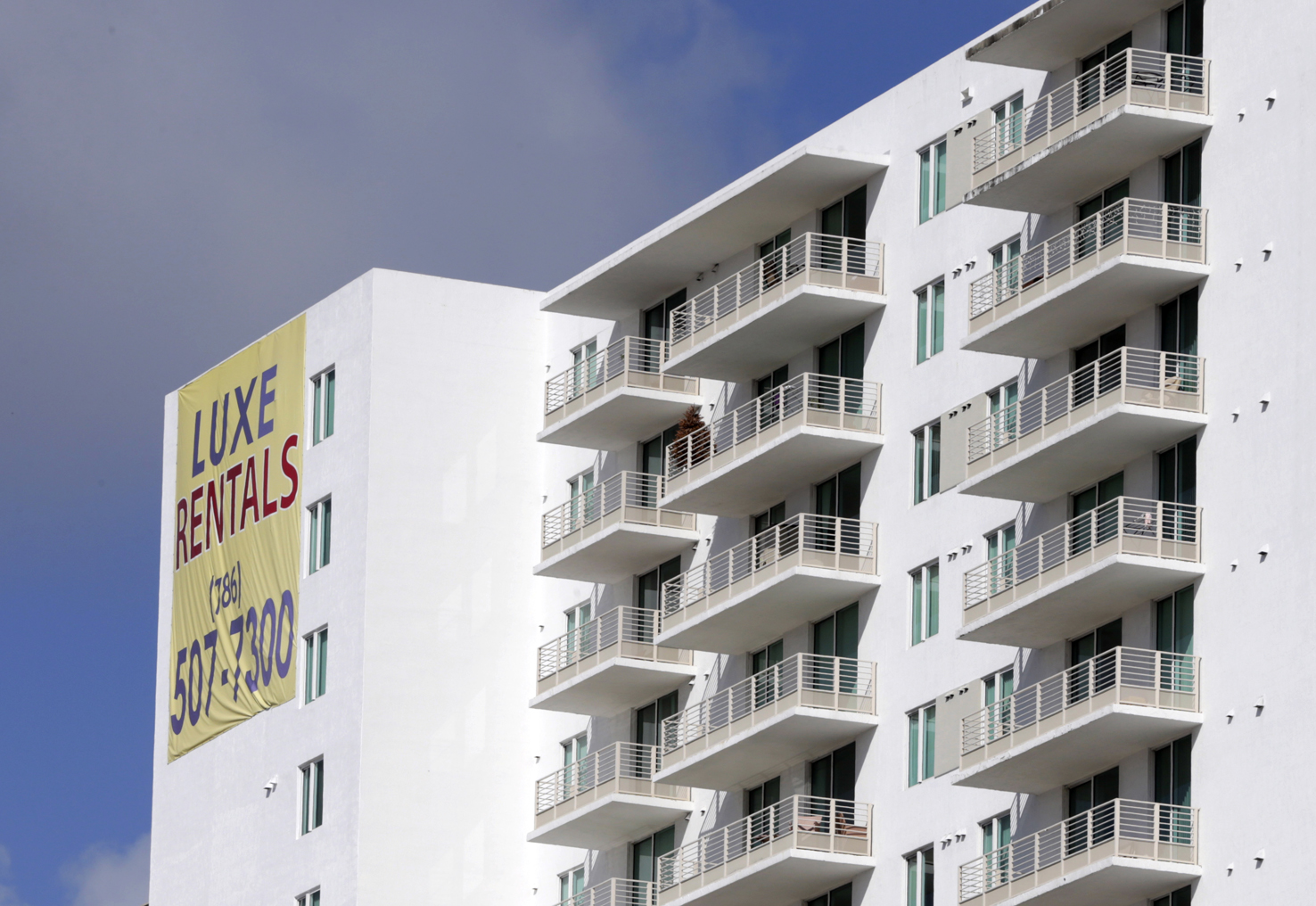 FILE - In this Tuesday, Feb. 2, 2016, photo, newly built apartments are advertised for rent in downtown Miami. On Friday, April 22, 2016, the real estate firm Zillow will release median home rental prices for March. (AP Photo/Lynne Sladky, File)