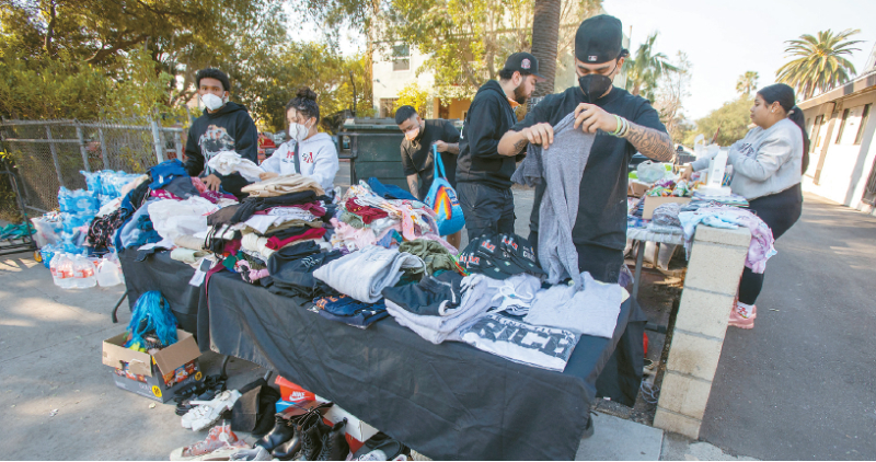Residents who were not affected by the fire are organizing clothing to be distributed for free to victims on the streets of Altadena. [Courtesy of Reuters]