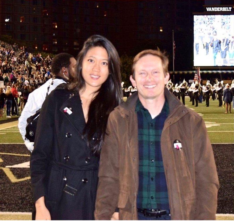 Sarah Lee Best (left) and her husband, Daniel Solomon, at a Vanderbilt University football event. [Courtesy of Young-Joo Kang]