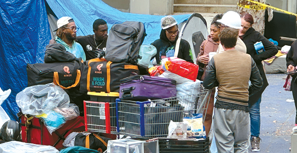 LA homeless budget cuts impact outreach worker checking tents