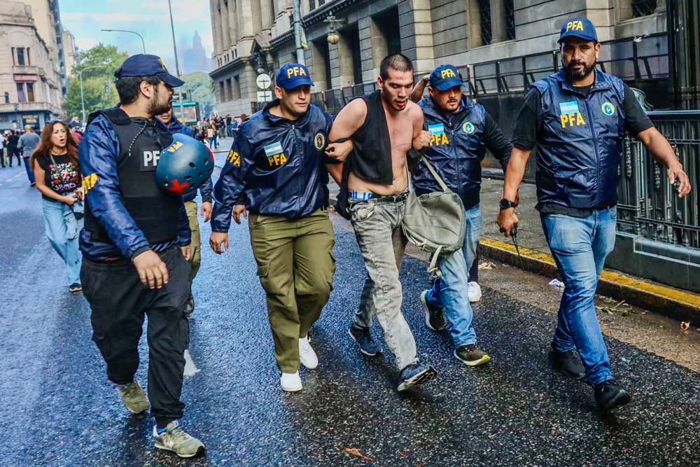 Argentine police detain a protester amid Javier Milei’s reform protests.