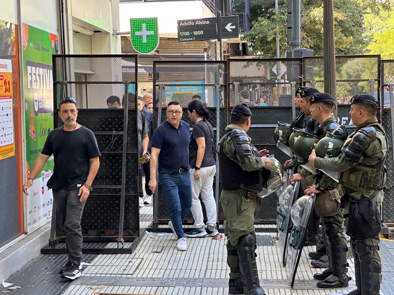Protesters navigate a narrow passage between police barricades in Buenos Aires.