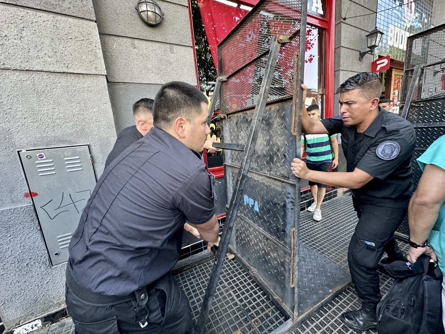 Argentine Federal Police officers install metal barricades to block access to Congress.
