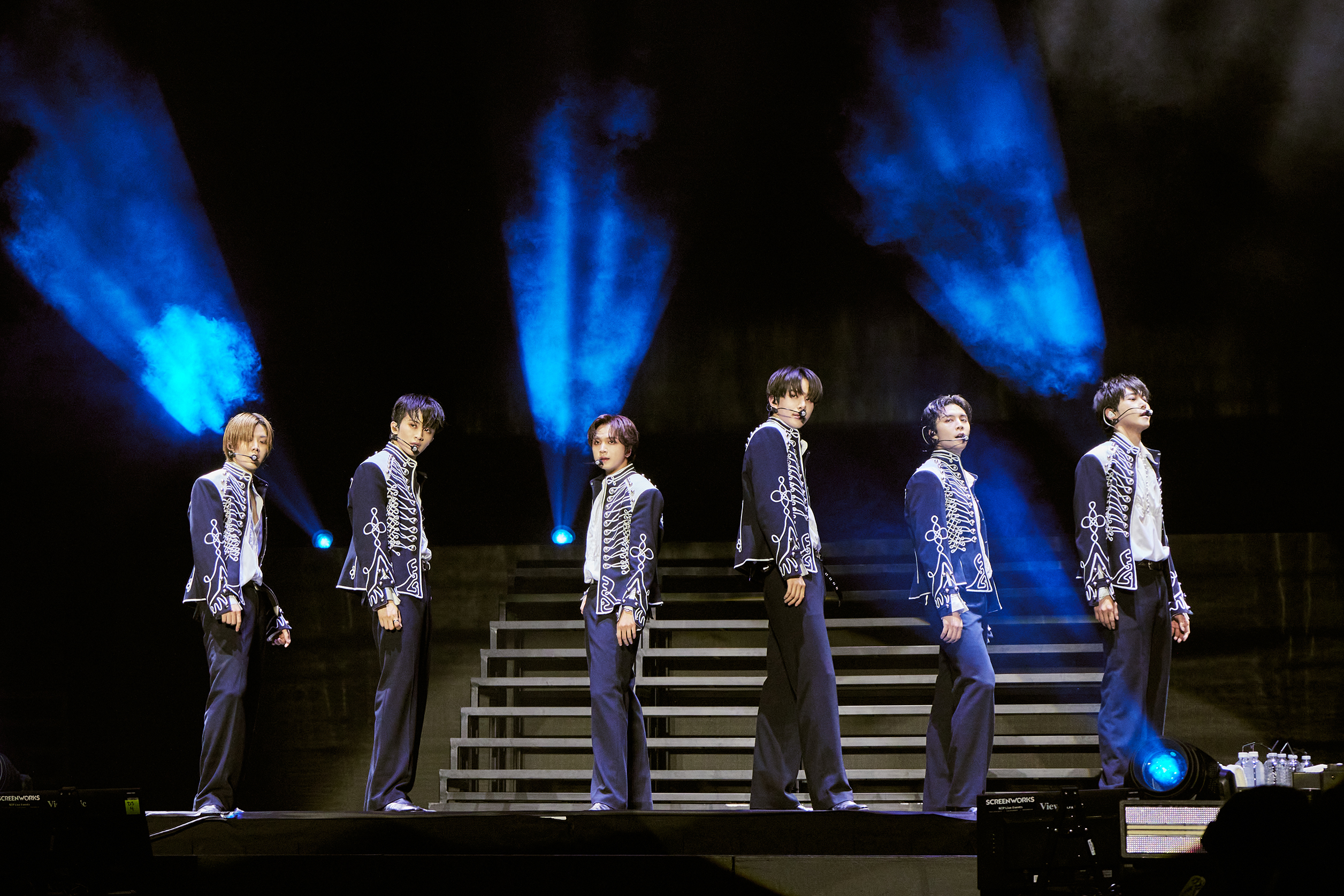 NCT 127 performing No Clue in sleek formalwear before launching into Sticker.