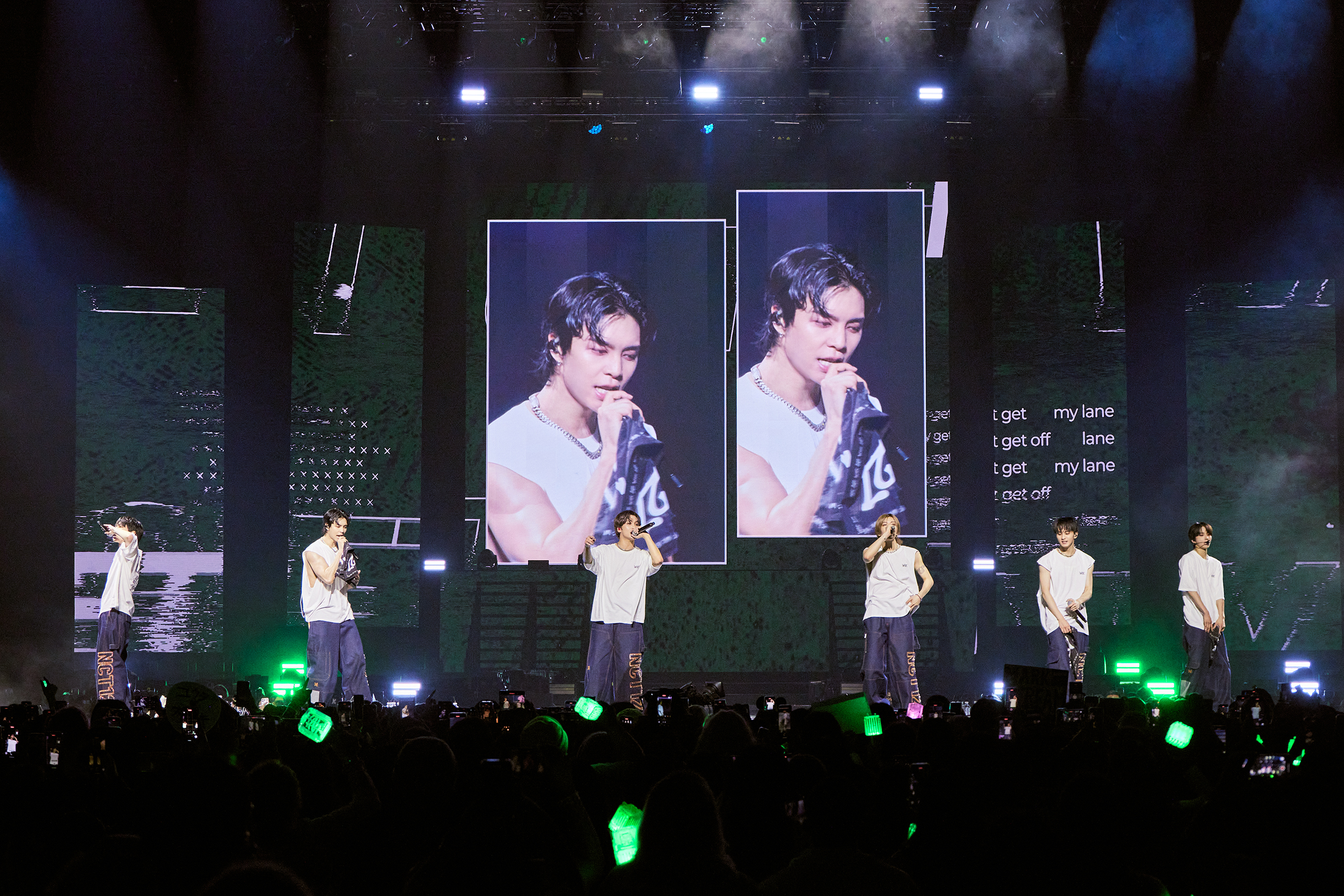 NCT 127 performing Walk in white T-shirts and denim, delivering the final big impact.