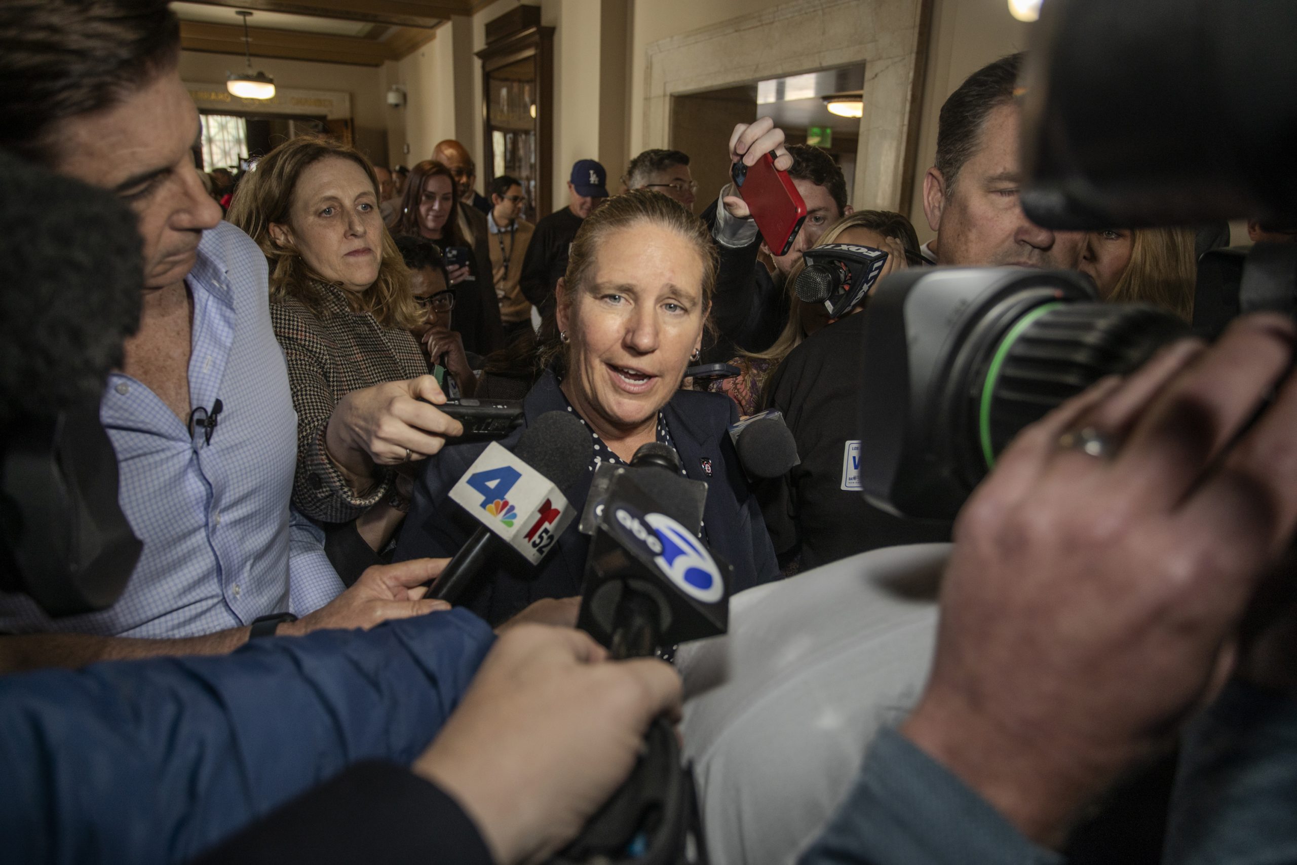 Former LA Fire Chief Kristin Crowley walks out of City Hall, surrounded by media, after the City Council denies her appeal in a 13-2 vote.
