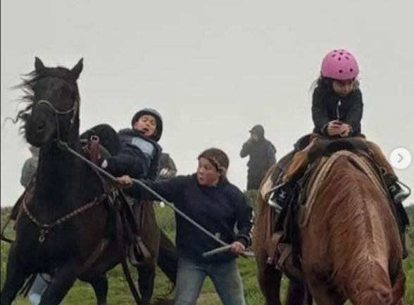 A young boy falls off a horse during a riding lesson in California.