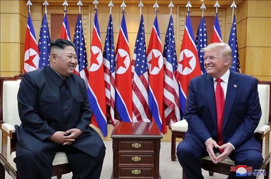North Korea’s leader Kim Jong-un, left, and former U.S. President Donald Trump smile during a meeting on the south side of the Military Demarcation Line that divides South and North Korea on June 30, 2019. [YONHAP]