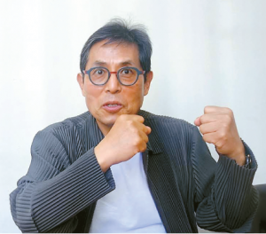 Palisades fire hero Jin Kwang-seok gestures during interview