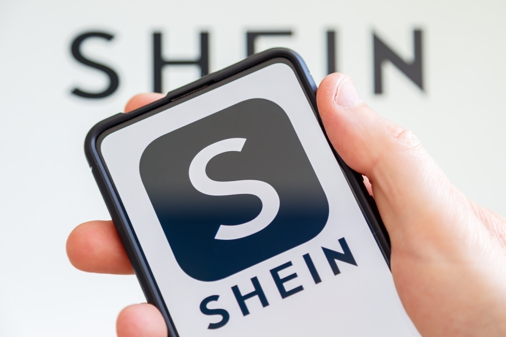 Shein logo on phone screen in copyright infringement lawsuit