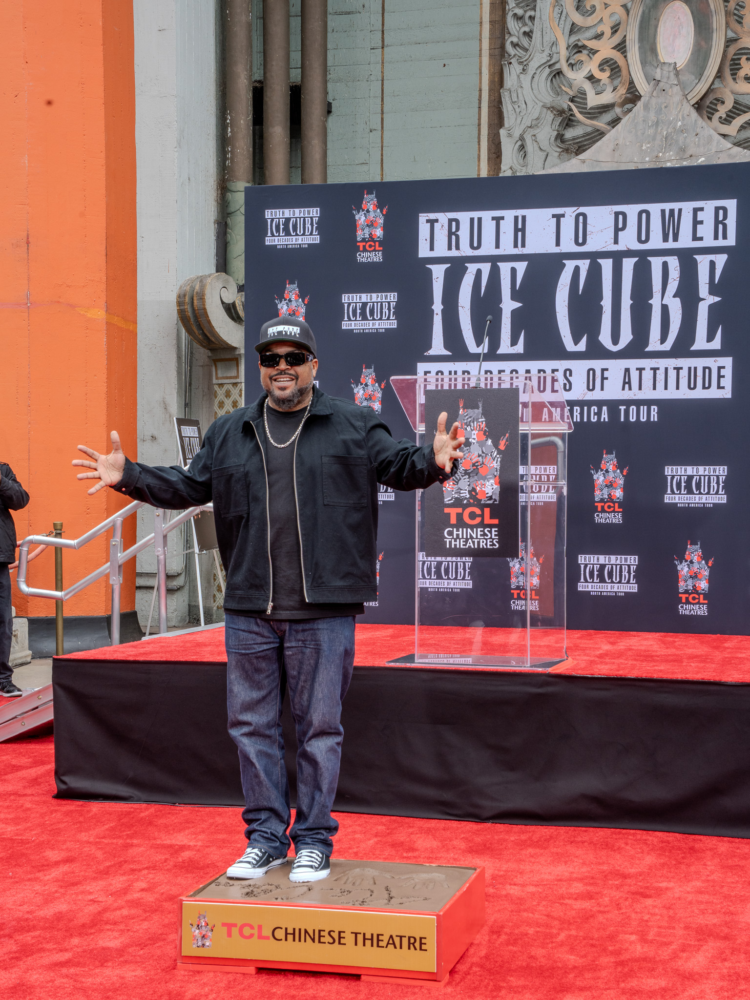 Ice Cube pressing foot into cement at TCL Chinese Theatre
