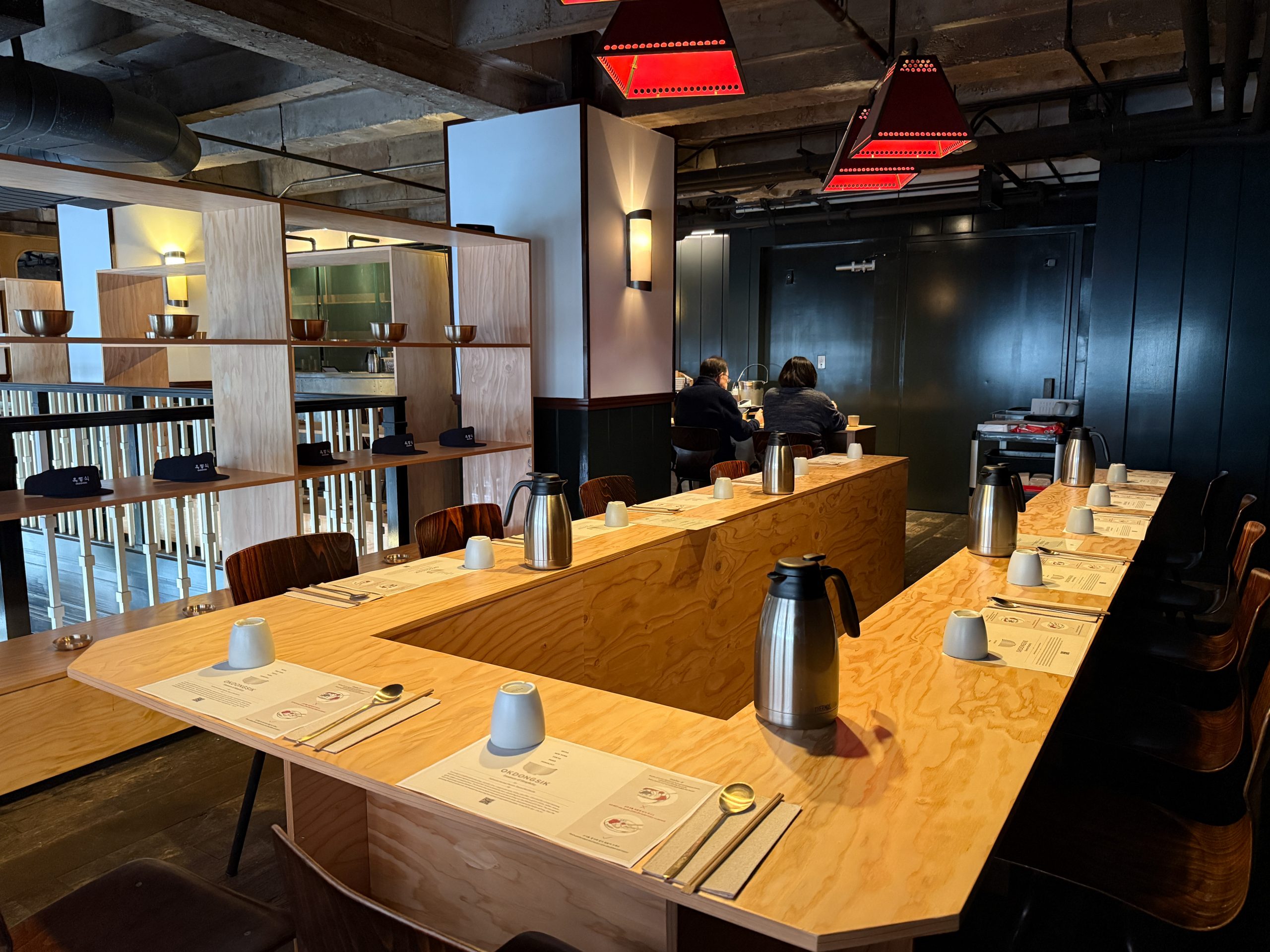 Wooden seating inside Okdongsikโs LA pop-up restaurant