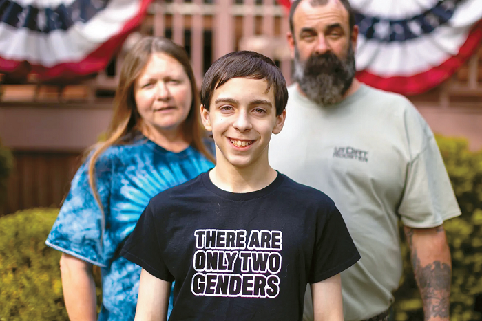 Liam Morrison wearing “There are only two genders” shirt with parents during legal challenge