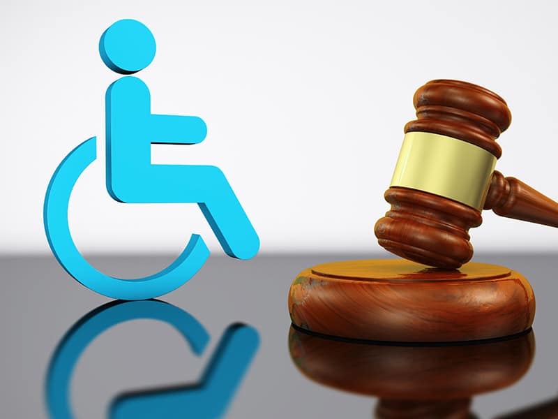 Judge’s gavel and wheelchair symbol representing ADA lawsuit abuse