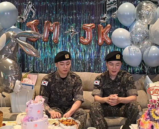 BTS members Jungkook, left, and Jimin during a livestream on fan community platform Weverse on June 11, the day they were discharged from their military duties [SCREEN CAPTURE]