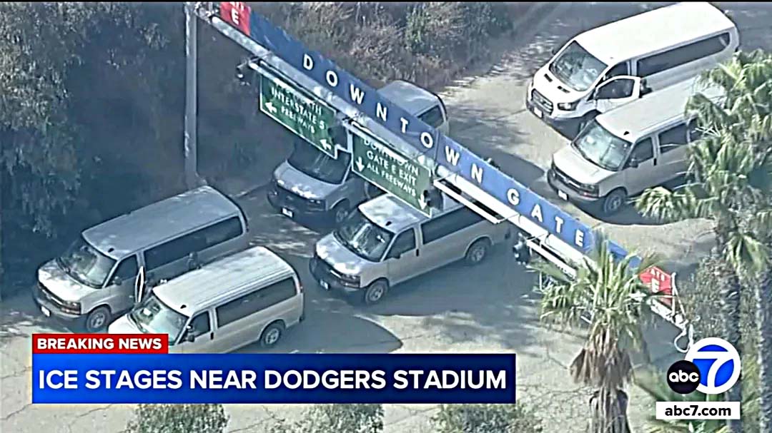 Several white vans, believed to be affiliated with U.S. Customs and Border Protection (CBP), attempt to enter Dodger Stadium through Gate E on June 19. [ABC7 screenshot]