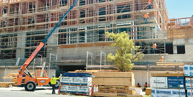 Apartment construction site in Los Angeles Koreatown with building framework and cranes visible