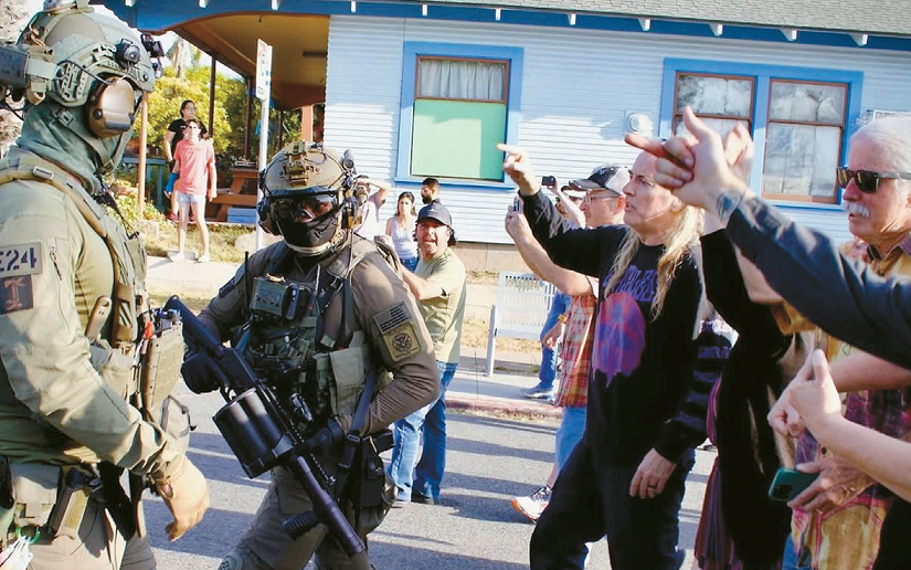 ICE agents and activists confront each other during a deportation operation outside Buona Forchetta in San Diego