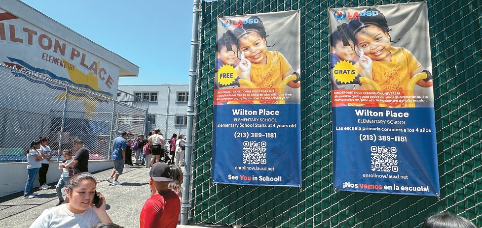 Wilton Place Elementary front gate with banner promoting Koreatown elementary school enrollment