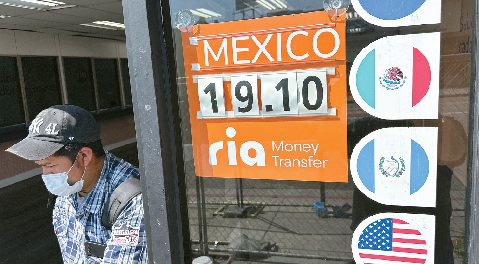 Exchange rate sign for Mexican peso outside LA remittance business amid remittance tax debate