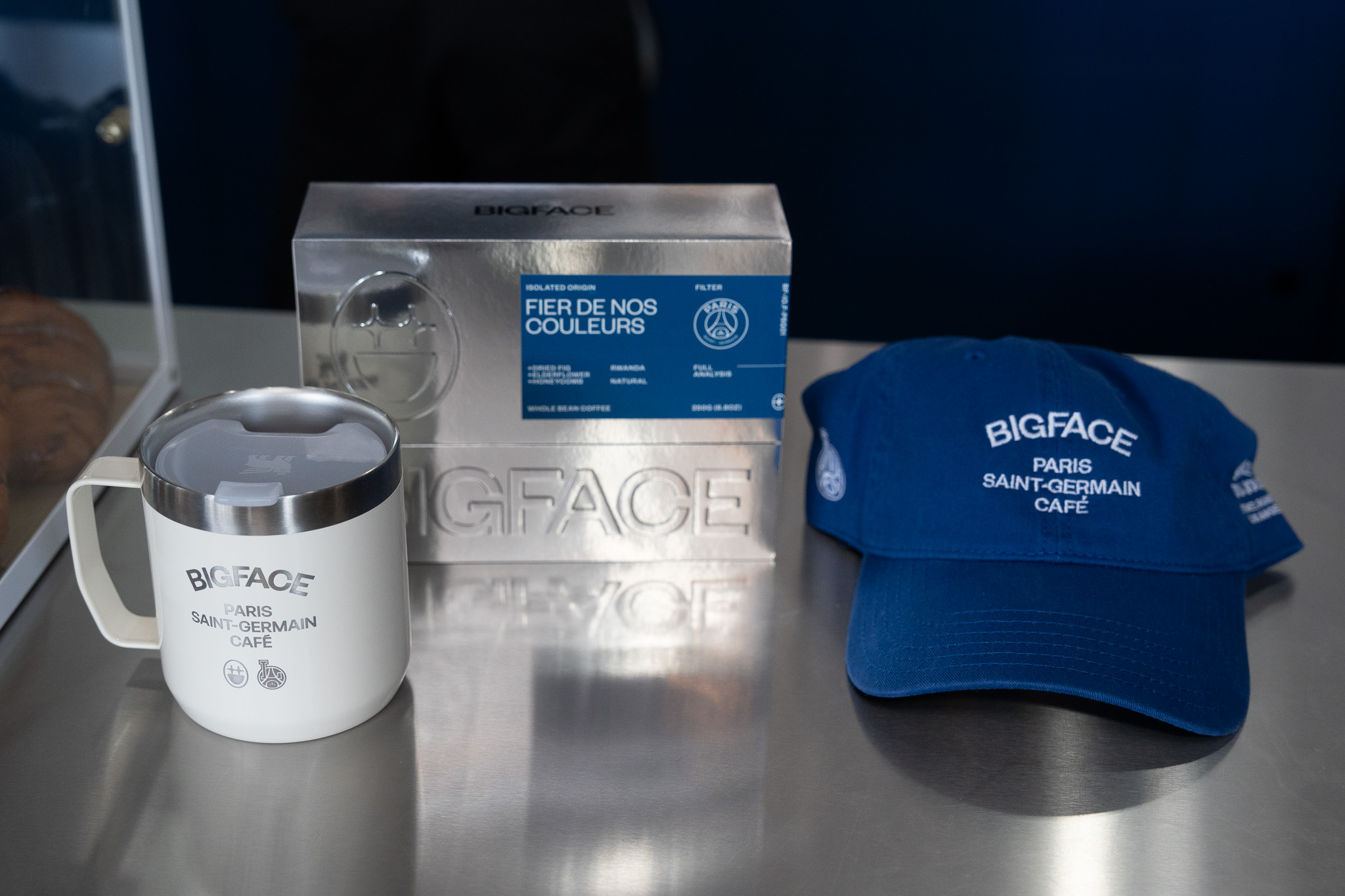 Bigface Coffee and PSG collab merchandise on display with cap, coffee, and branded cup