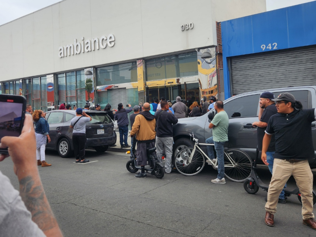 Crowd gathers outside Korean-owned Ambiance store during immigration raids in downtown Los Angeles