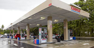 Costco gas station with white canopy and red-lettered signage, representing planned standalone station in Mission Viejo
