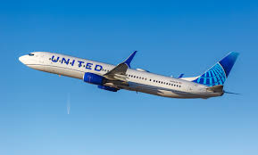 United Airlines plane mid-flight with clear sky, related to racial discrimination lawsuit