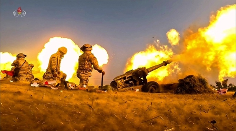 North Korean leader Kim Jong-un watches an artillery firing competition among large combined units of the North Korean army on May 29. [YONHAP]
