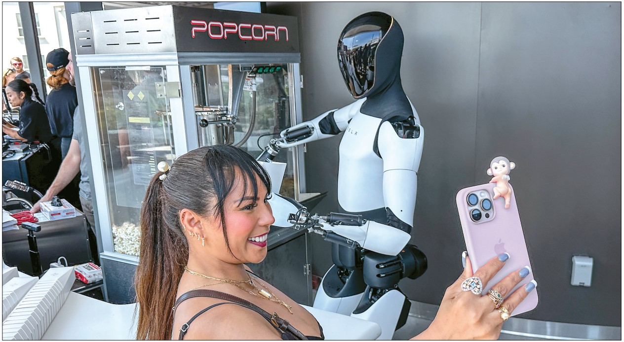 Optimus robot at Tesla Diner Hollywood rooftop with visitor posing