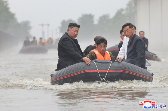 North Korean leader Kim Jong-un rides a boat to oversee areas flooded by torrential rains on July 31, 2024, in this photo released by the state-run Korean Central News Agency. [YONHAP]