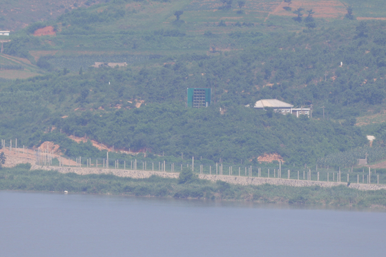 The area surrounding a loudspeaker used for anti-South Korea broadcasts in Kaepung County, North Hwanghae Province in North Korea is seen from the Odusan Unification Observatory in Paju, Gyeonggi, on July 29. [YONHAP]