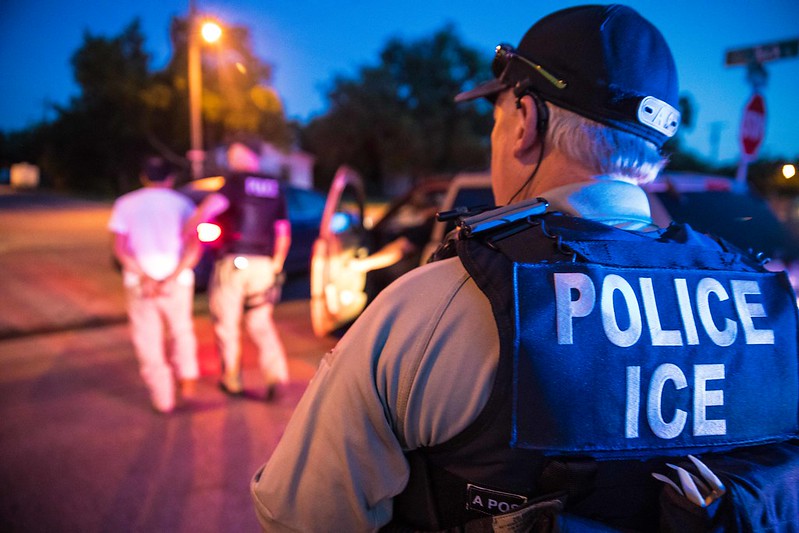 ICE officer conducts immigration enforcement operation in minority neighborhood
