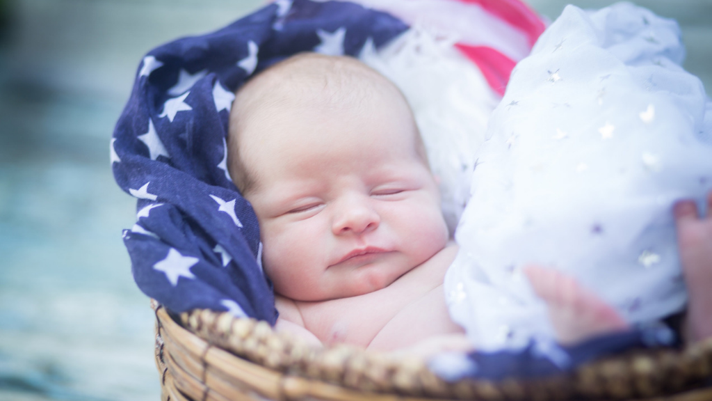 baby in basket with American flag related to birthright citizenship restrictions