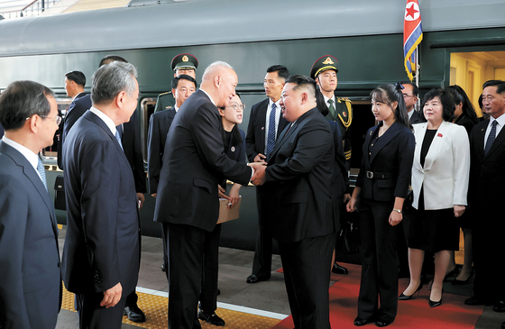 North Korean leader Kim Jong-un is welcomed by Chinese officials as he arrives at Beijing Station in China on Sept. 2 at around 4 p.m. Behind him is his daughter, Ju-ae. [KCNA]