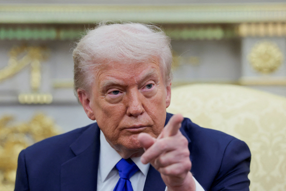 U.S. President Donald Trump gestures as he and Canada's Prime Minister Mark Carney, not pictured, meet in the Oval Office at the White House in Washington on Oct. 7. [REUTERS]
