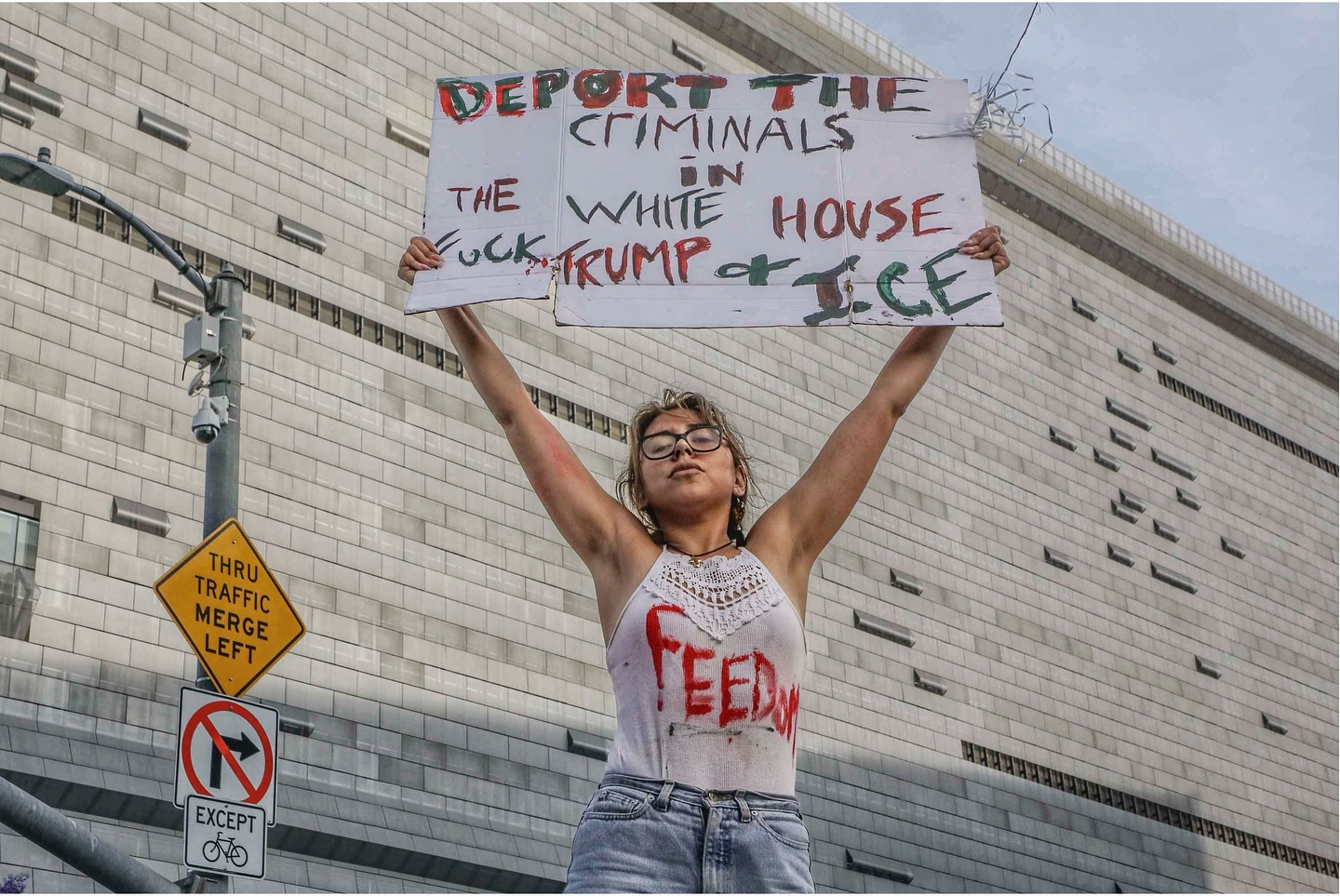 A protester holds a sign during a DTLA demonstration on June 14 regarding immigration status concerns.