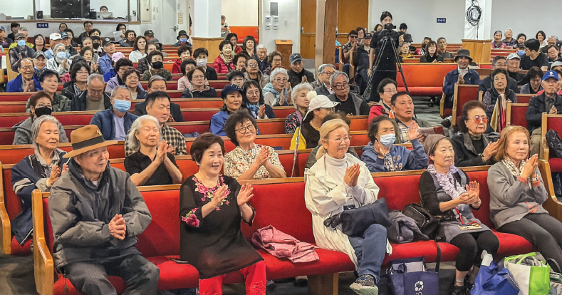 Attendees applaud a healthcare seminar during the Korean American senior expo in Koreatown.