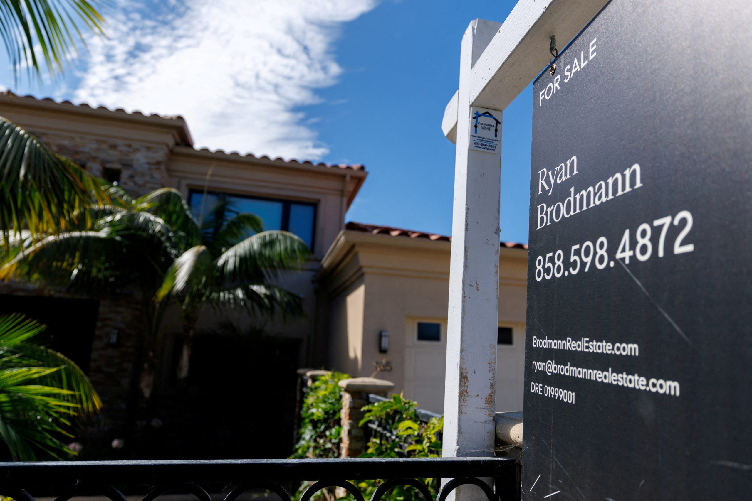 A residential home for sale sign is shown in California